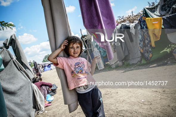 A refugee girl at a makeshift refugee camp on the Serbian side of the border with Hungary near the town of Horgos on August 12, 2016. 