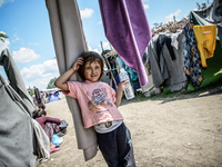 A refugee girl at a makeshift refugee camp on the Serbian side of the border with Hungary near the town of Horgos on August 12, 2016. (