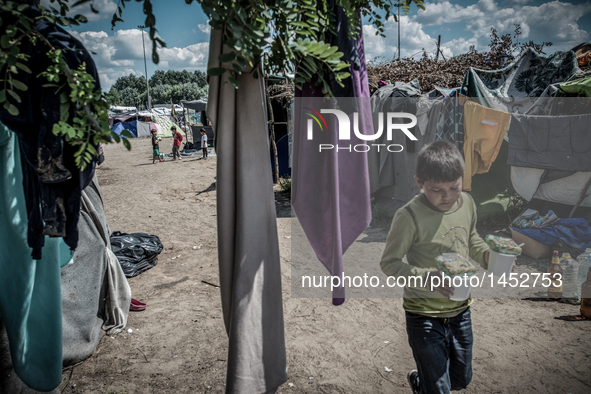 Refugees at a makeshift refugee camp on the Serbian side of the border with Hungary near the town of Horgos on August 12, 2016. 