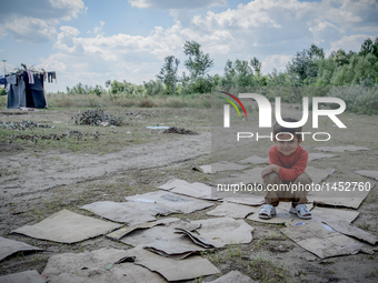 A refugee boy at a makeshift refugee camp on the Serbian side of the border with Hungary near the town of Horgos on August 12, 2016. (