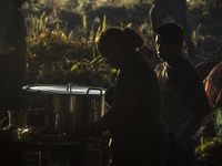 Men and women from FARC EP cook their food in the improvised kitchens inside the jungle by the savannas  in Llanos del Yari, a town in an In...