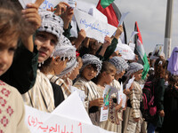 Palestinian boys take part in a rally in support of a Gaza-bound flotilla of international activists attempting to break the Gaza blockade,...