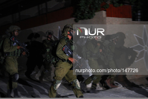 Ramallah, West Bank, Palestine: Israeli soldiers take positions during a raid in Aaroura village in the north-west of the city of Ramallah,...
