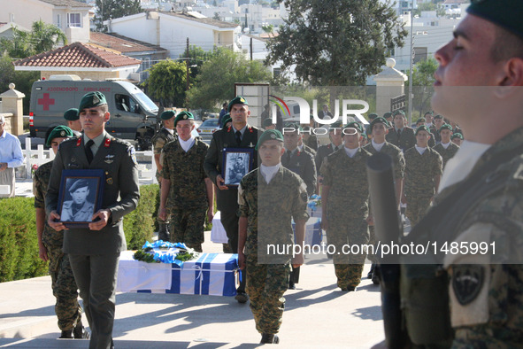 Soldiers carry the coffins and photographs during a handover remains ceremony at a military cemetery in Nicosia, Cyprus, on Oct. 4, 2016. Cy...