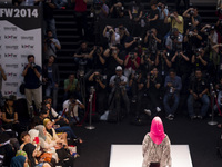 A model shows creations of respective designers during the Islamic Fashion Festival at the Malaysia International Fashion Week in Kuala Lump...