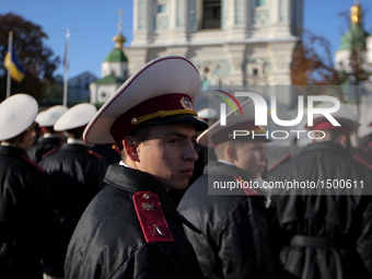 A cadet turns about as cadets stand during an oath taking ceremony in front of St. Sofia Cathedral in Kiev. Ukraine, Friday, Oct. 14, 2016....