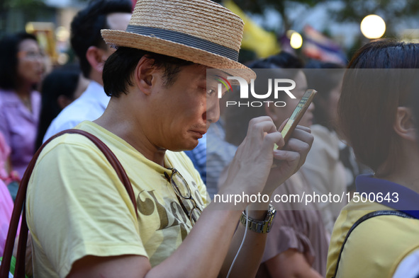 A man checks news about the death of Thai King Bhumibol Adulyadej outside Siriraj Hospital in Bangkok, capital of Thailand, on Oct. 13, 2016...