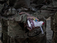 Soldier of Azov battalion holds the Ukrainian traditional amulet (