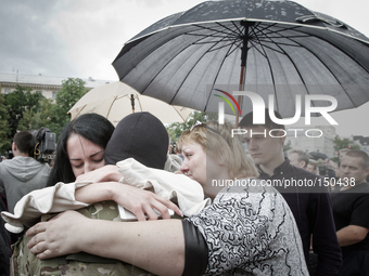 Crying girlfriend and mother hug a combatant of Azov battalion who departs to ATO zone (
