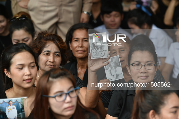 Thai people hold pictures of Thai King Bhumibol Adulyadej near the Grand Palace in Bangkok, Thailand, on Oct. 14, 2016. The remains of Thai...