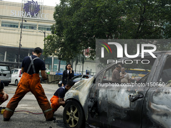 Aftermath of car engulfed in fire incident in Kuala Lumpur, Malaysia, Friday, June 20, 2014.(