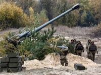 Ukrainian servicemen fire a 2A65 Msta-B howitzer during military exercises near the village of Divychky in Kyiv region, Ukraine, October 21,...