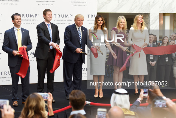 U.S. Republican presidential nominee Donald Trump (3rd L) and his family members cut the ribbon during the opening and ribbon cutting ceremo...