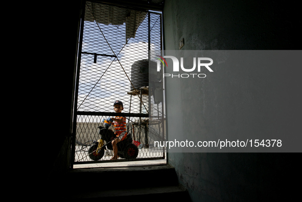 A Palestinian child in their home a near of the sea beach in the central Gaza Strip on June 26, 2014. Palestinian Environment Quality Author...