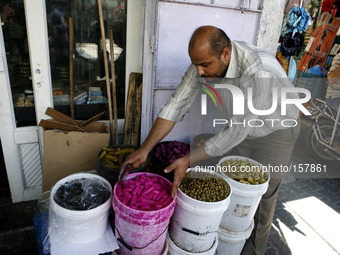A Palestinian vendors displays imported the pickles traditional Ramadan at a market in Rafah in the southern Gaza Strip on June 28, 2014. St...