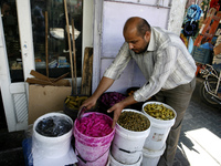 A Palestinian vendors displays imported the pickles traditional Ramadan at a market in Rafah in the southern Gaza Strip on June 28, 2014. St...
