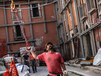 A man at work for the rebuilding of a damaged building after the quake of April 6, 2009 in L'Aquila, Italy, on July 2, 2014. (