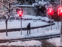 People walk during snowfalls in Istanbul on January 7, 2017. A heavy snowstorm paralysed life in Istanbul with hundreds of flights cancelled...