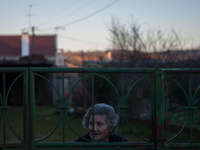 A woman watches the parade from her house, in Salsas, Portugal on Janaury 7, 2017. These solstice festivals, which have their origins in ear...