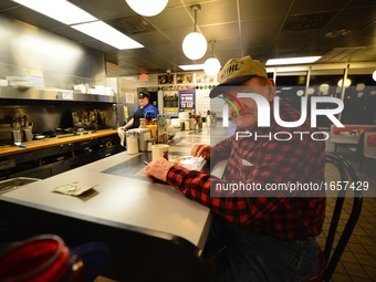 At a Frederick, Maryland, Waffle House Joe Schumacher, 77, of Middletown, Maryland is getting ready for work as the nation prepares for Inau...