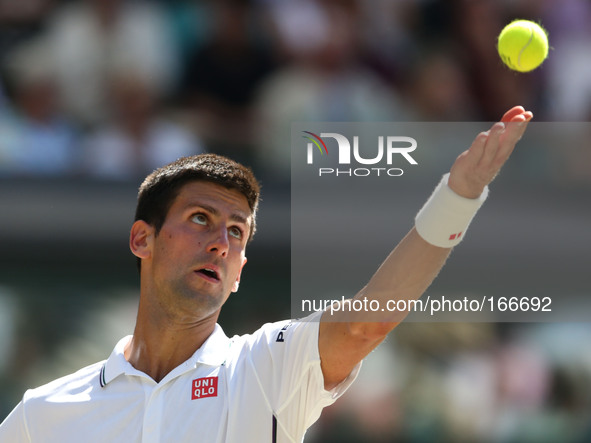 (140704) -- LONDON, July 4, 2014 () -- Serbia's Novak Djokovic serves during the men's singles semi-final match against Bulgaria's Grigor Di...