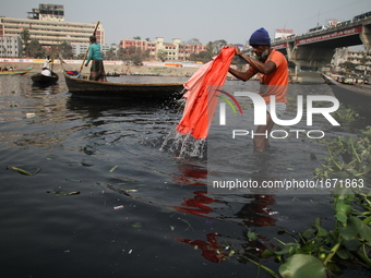 A man washes cloths with polluted water on the bank of Buriganga River in Dhaka, Bangladesh on January 24, 2017.   (