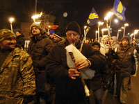 Ukrainian nationalists carry torches during march to mark the 99th anniversary of a battle near Ukrainian city Kruty, in Kiev, Ukraine, 29 J...