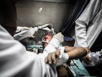 A child is treated in Gaza City after being injured during Israeli targeted airstrikes, on July 9, 2014. Countless airstrikes have hit targe...