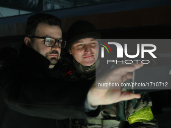 The Head of a State Agency on Film Production Pylyp Illienko (L) makes a selfie with one of the 