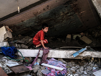 A palestinian children in a destroyed house after Israeli air strike in Gaza City, on July 10, 2014. The Israeli air force overnight hit mor...