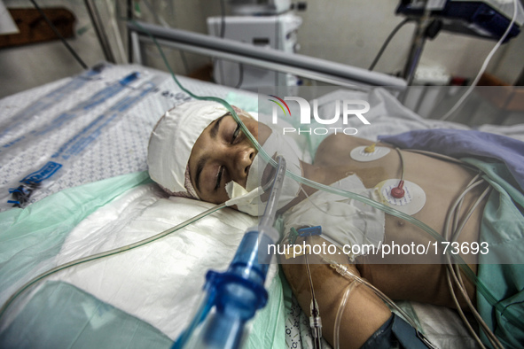 A injured child into a hospital in Gaza City after an Israeli airstrike, on July 10, 2014. The Palestinian death toll has risen to 88 as Isr...