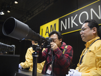 Nikon showcases their telephoto lenses at the Nikon booth at the CP+ Camera and Photo Imaging Show in Yokohama, Kanagawa, Japan, on Thursday...