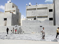 A Palestinians inspect the rubble of a destroyed governmental prison after an Israeli air strike in Rafah in the southern Gaza Strip, July 1...