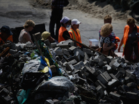 Yellow-blue Ukrainian flag is seen on the pile of demolition waste the barricade is built from. (