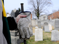 People assess the damage after hundreds of headstones got vandalized at Mt. Carmel Jewish Cemetery in Northwest Philadelphia, PA, on Feb. 27...