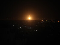 A photo taken on July 16, 2014 from the southern Israeli Gaza border shows Israeli army flares falling into the Palestinian enclave. (