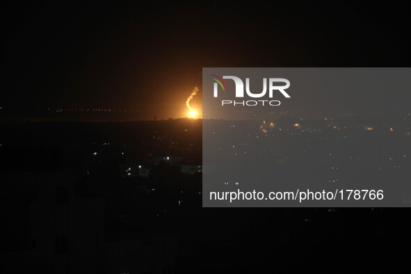 A photo taken on July 16, 2014 from the southern Israeli Gaza border shows Israeli army flares falling into the Palestinian enclave. 