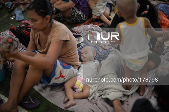 Filipinos occupy a basketball court converted into an evacuation center in Manila, Philippines, July 16, 2014. Typhoon Rammasun left at leas...