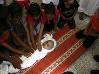 Palestinian relatives of five-month-old Palestinian child, Lma  al-Satary, mourns during his funeral in Rafah, in the southern Gaza Strip on...