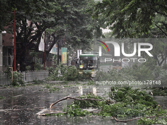 Makati City, Philippines - A commuter bus makes its way through debris brought down by Typhoon Rammasun on July 16, 2014. Typhoon Rammasun (...