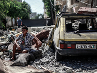 A Palestinian citizen inspects a destroyed house following an Israeli airstrike in Gaza city, on July 16, 2014.
Israel resumed its air strik...