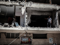 A Palestinian citizen inspects a destroyed house following an Israeli airstrike in Gaza city, on July 16, 2014.
Israel resumed its air strik...