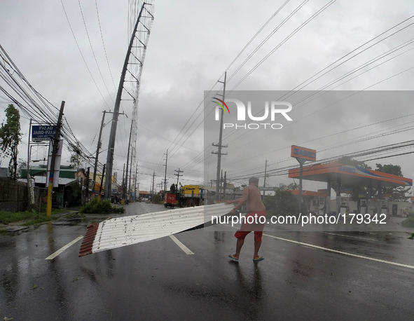 (140716) -- CAVITE PROVINCE, July 16, 2014 () -- A man clears a rod of galvanized iron that was blown away by typhoon Rammasun in Cavite Pro...