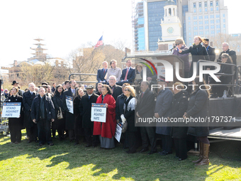 Independence Hall is seen in the background as Interfaith Church and Community leaders are joined by local elected officials at a March 2, 2...