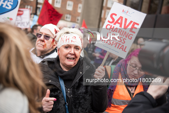  A protester holds up a placard during a demonstration in support of the NHS in Tavistock Square on March 4, 2017 in London, England. Thousa...