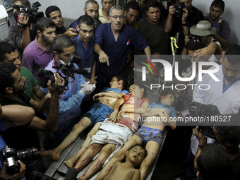 Palestinians look at bodies of four children, three of them from Shuhaiber family, Fulla Tariq Shuhaiber, Jihad Issam Shuhaiber and Waseem I...