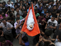 Palestinian mourners carry the body of Fulla Tariq Shuhaiber, 8 years, during her funeral in Gaza City on July 17, 2014. children were kille...