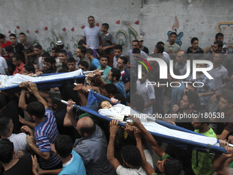 Relatives carry the bodies of two children from Shuhaiber family Jihad Issam Shuhaiber and Waseem Issam Shuhaiber during their funeral in Ga...
