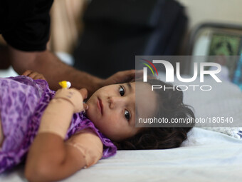 A young girl is being treated inside the emergency room in Shifa Hospital after a missile attack on her home in Gaza City on July 17th, 2014...