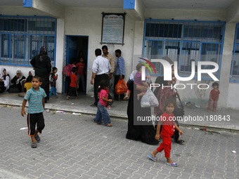 Palestinians sit inside the UNRWA school as they flee their houses following an Israeli ground offensive in Rafah in the southern Gaza Strip...
